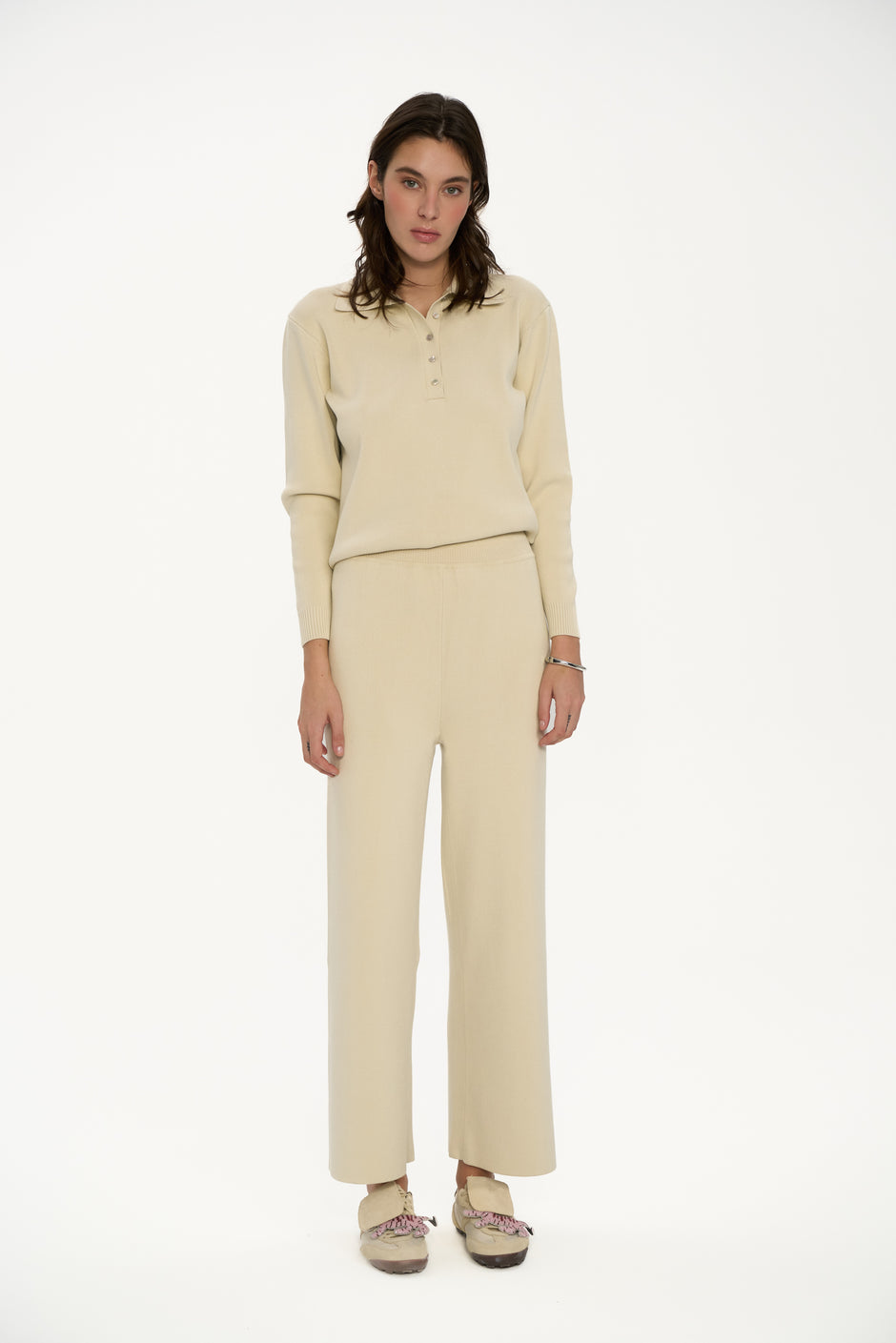 Woman wearing a beige outfit on a white background