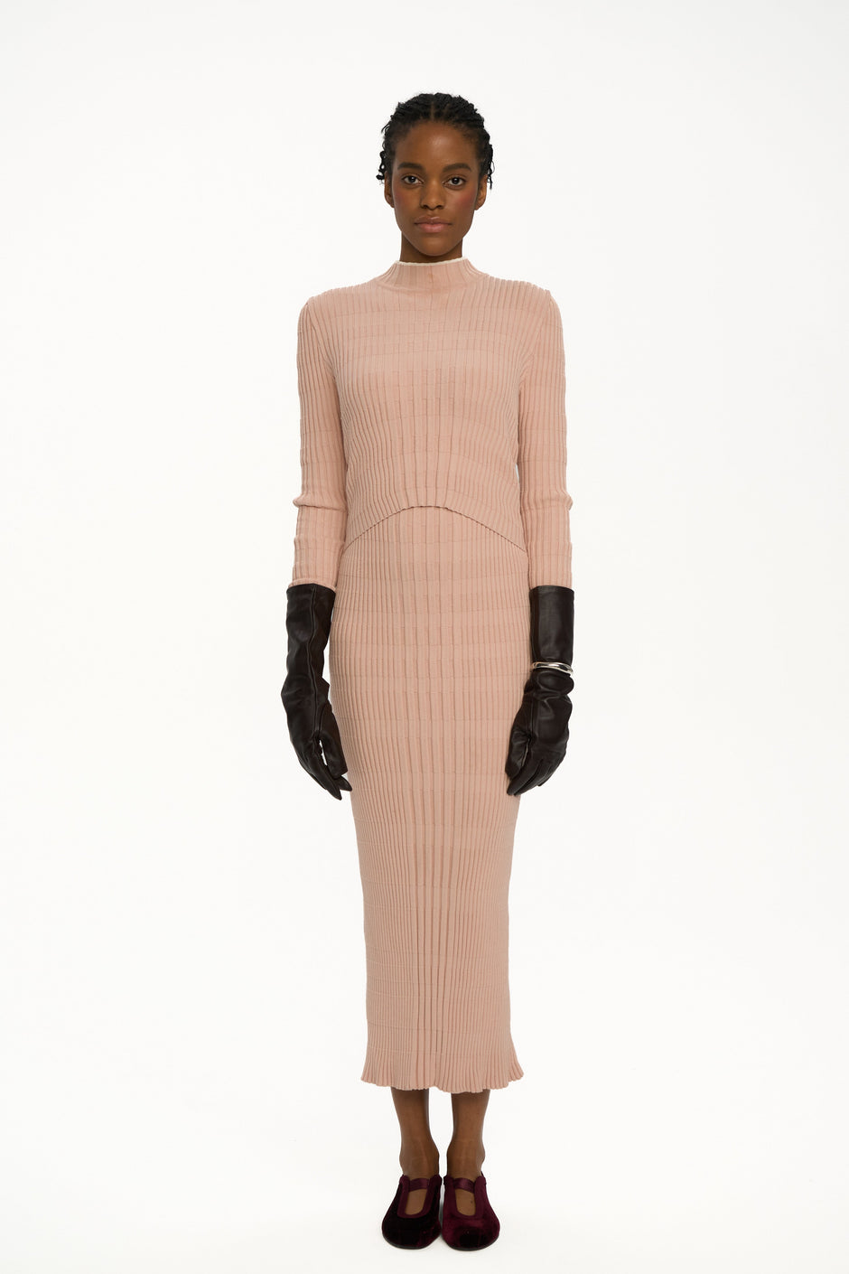 Blush pink ribbed knit midi dress with high neck and long sleeves on model wearing black gloves and velvet flats, breastfeeding-friendly double-layer design – Inner Tiger