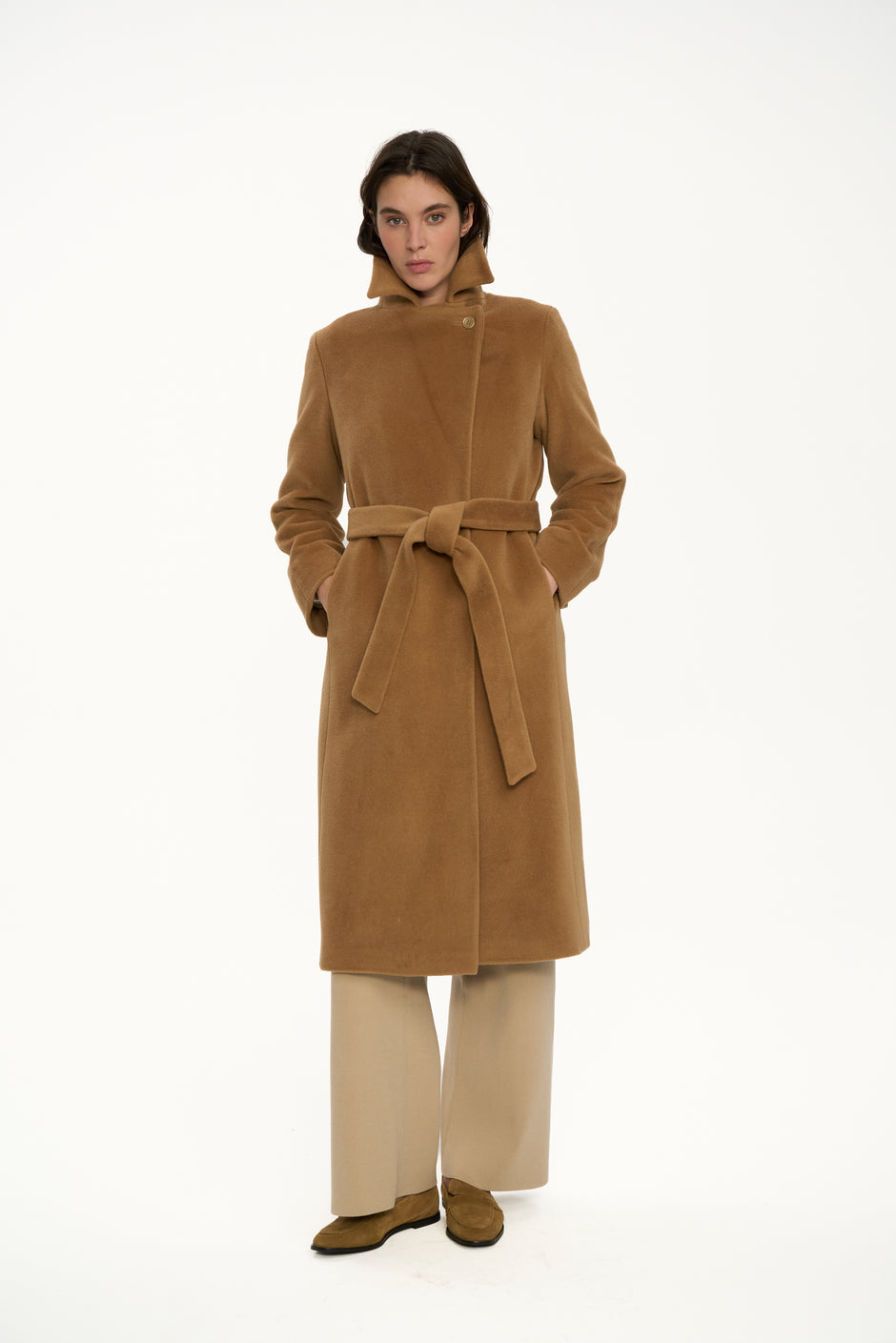Woman wearing a brown coat on a white background