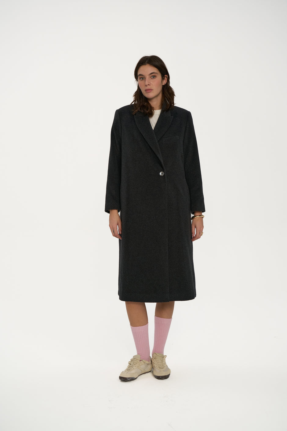 Charcoal wool single-breasted coat with notch lapels and one-button closure on model wearing cream top and sneakers, full length front view – Inner Tiger