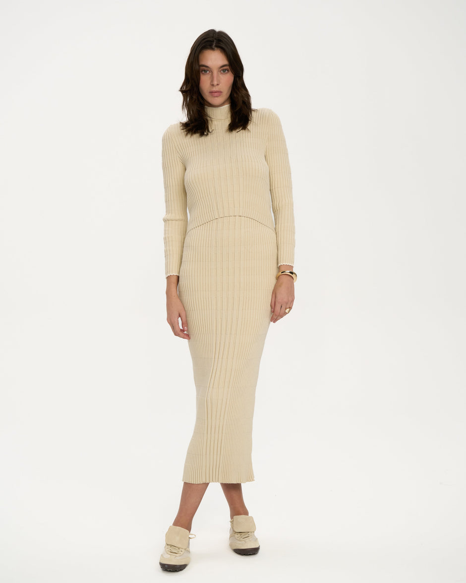 Cream ribbed knit midi dress with high neck and long sleeves on model in sneakers, breastfeeding-friendly double-layer design – Inner Tiger