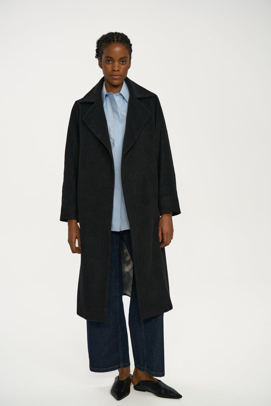 Dark charcoal cashmere wrap coat with wide lapels styled over light blue shirt and indigo wide-leg jeans on model, full length front view – Inner Tiger