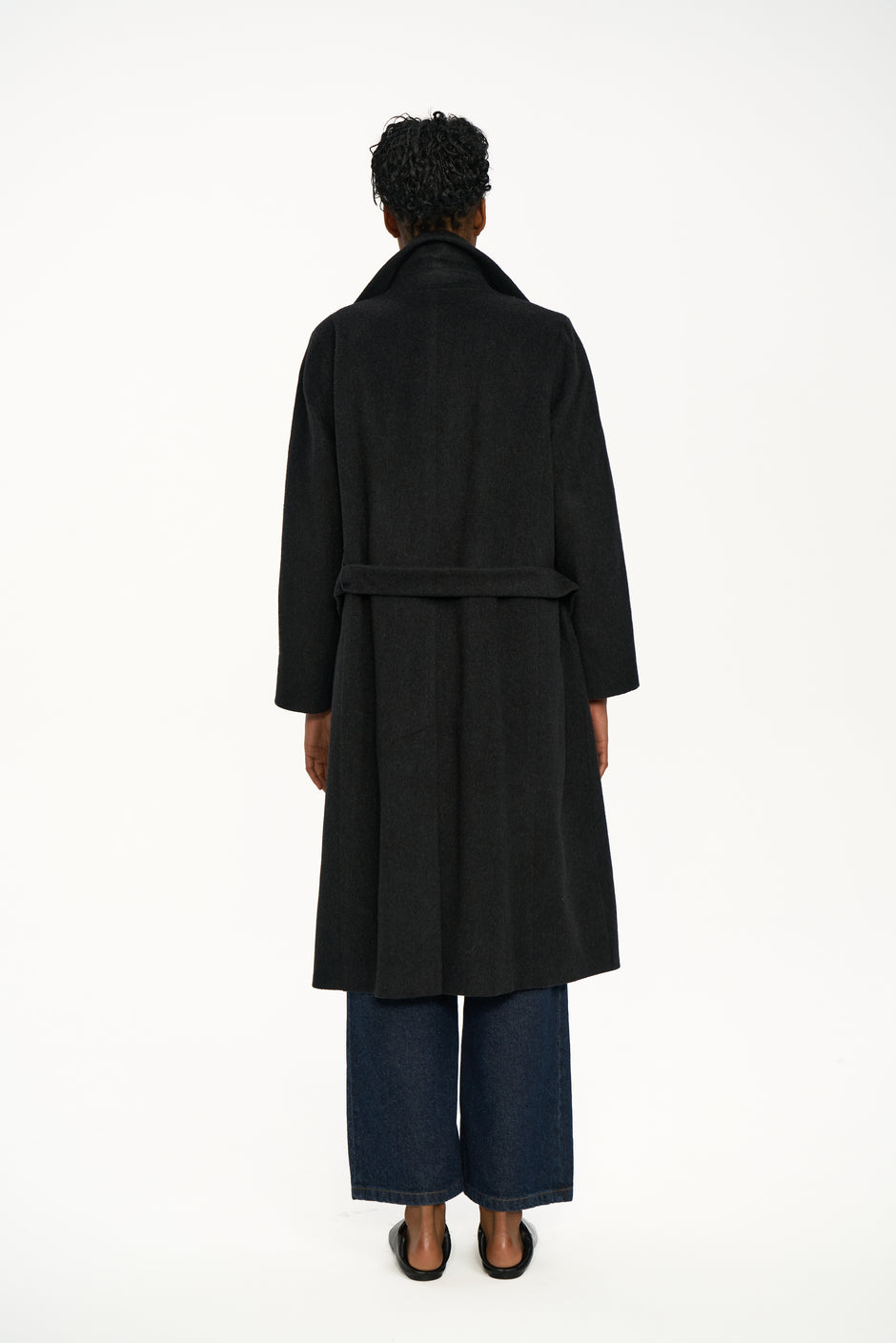 Back view of dark grey cashmere double-breasted wrap coat worn open with light blue shirt and wide jeans – Inner Tiger