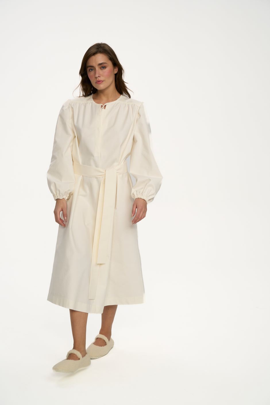 Front view of soft white freeform midi dress in organic cotton styled with cream slippers – Inner Tiger