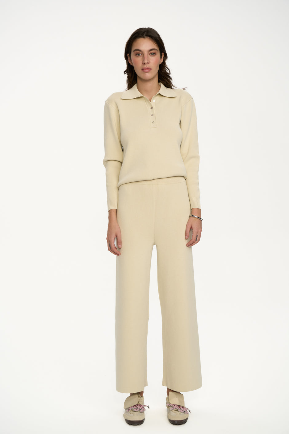 Woman wearing a beige outfit on a white background