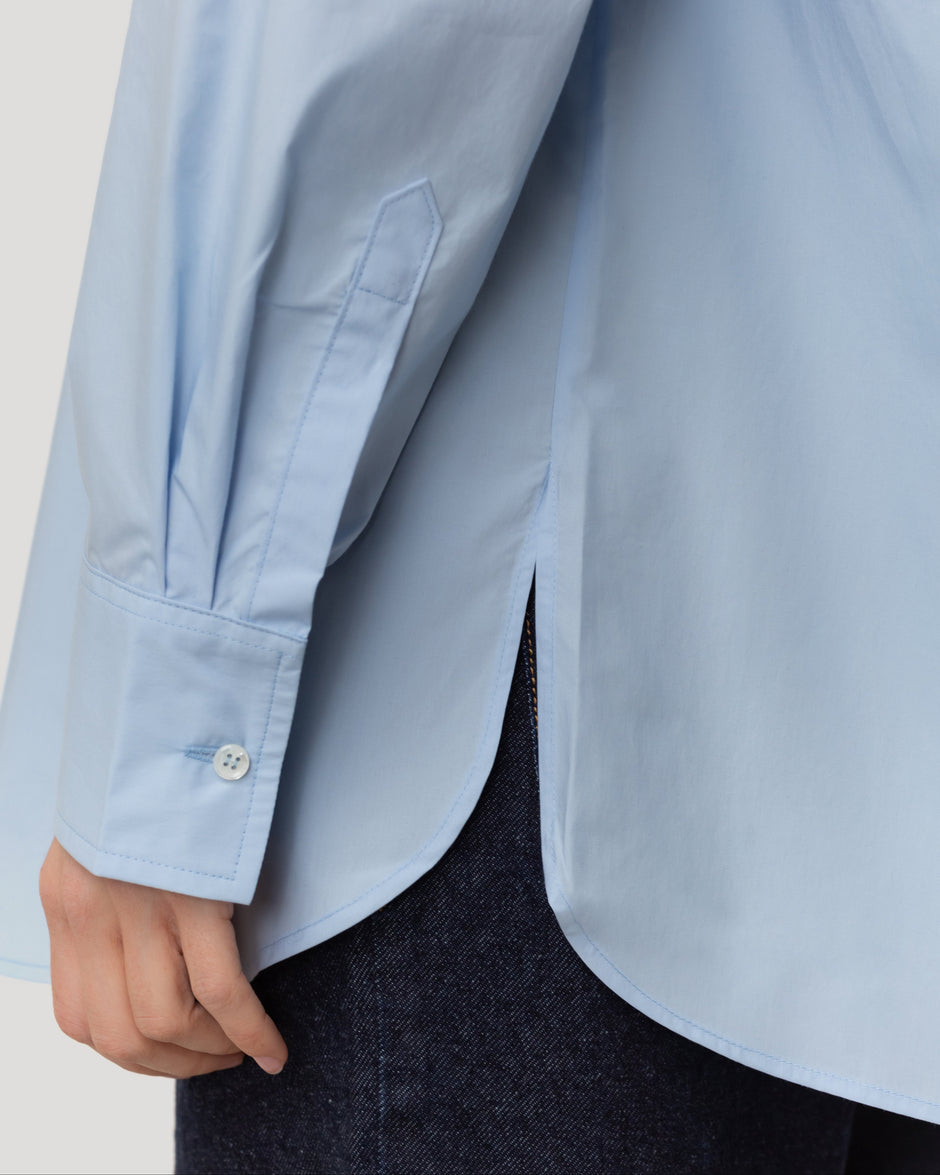 Close-up of light blue cotton shirt showing flap panels and clean collar, breastfeeding-friendly construction inside – Inner Tiger
