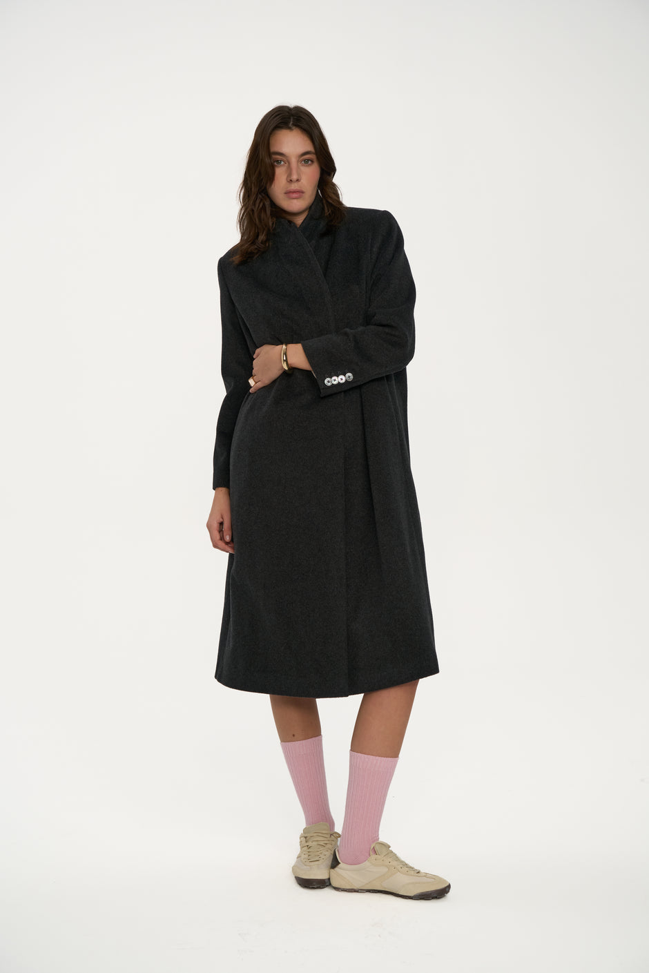 Woman wearing a black coat on a white background