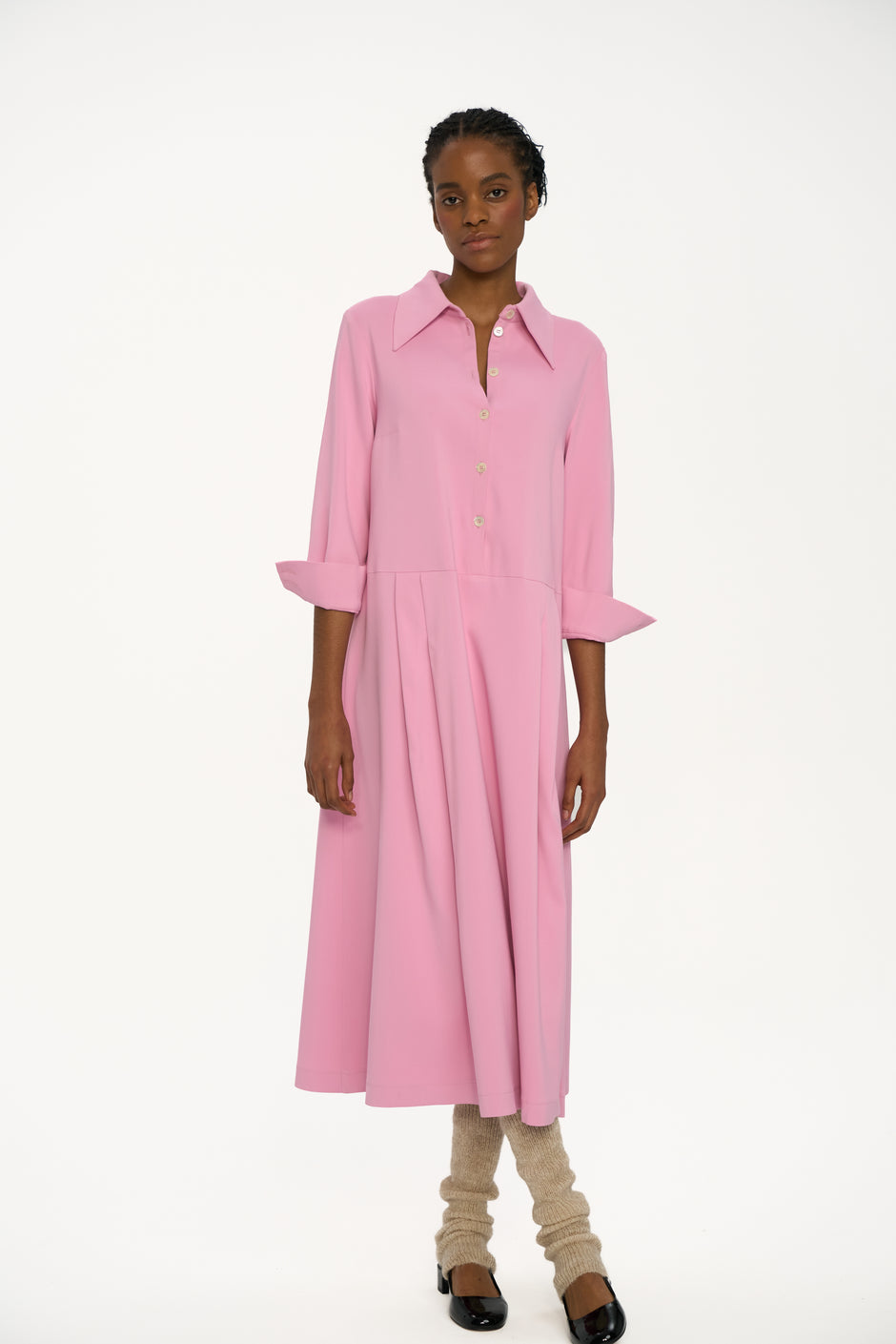 Person wearing a pink dress on a white background