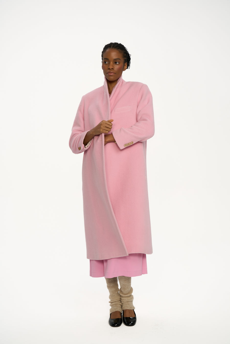 Person wearing a pink coat on a white background