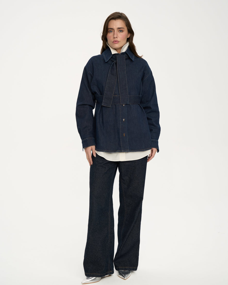 Indigo Italian denim bow overshirt belted at the waist, styled with wide-leg jeans and silver heels, full length front view – Inner Tiger