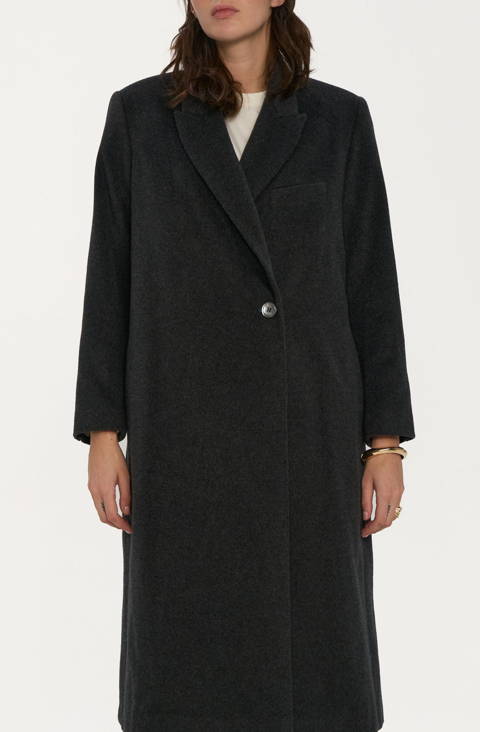 Person wearing a grey coat on a white background