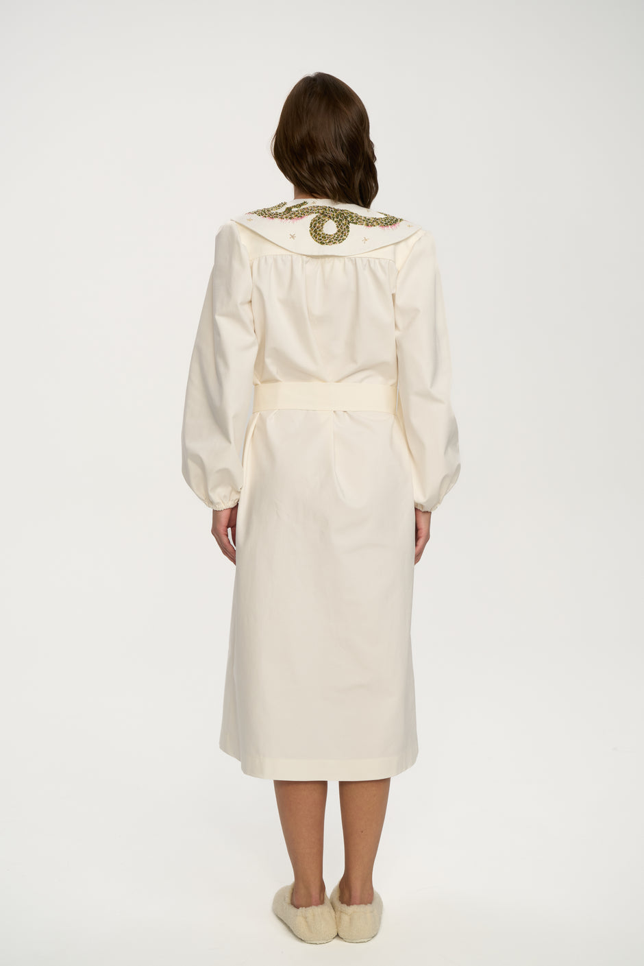 Minimal ice cream white organic cotton dress with straight neckline, volume sleeves and waist belt from back view– Inner Tiger